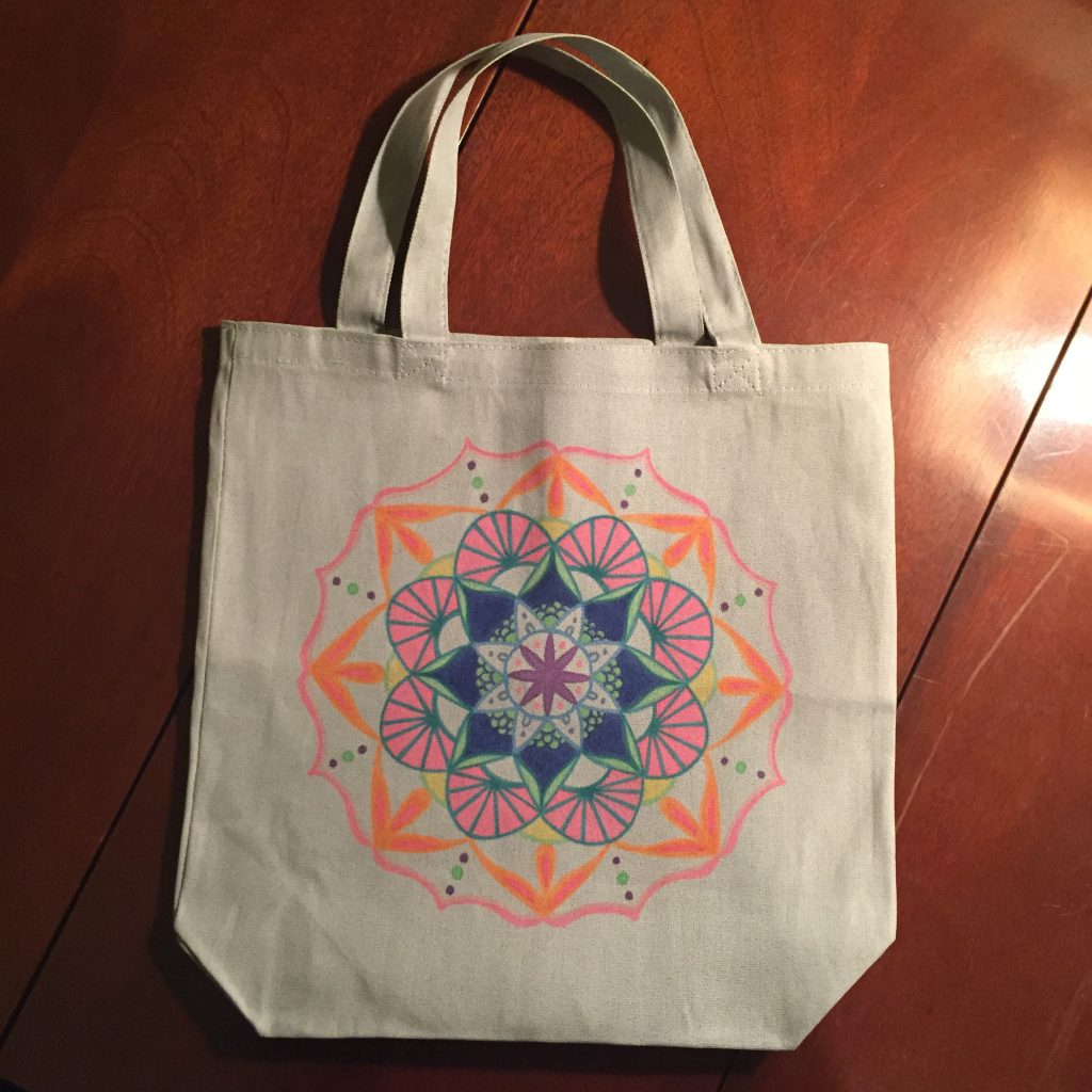 Hand drawn orange, blue and pink mandala on grey tote bag
