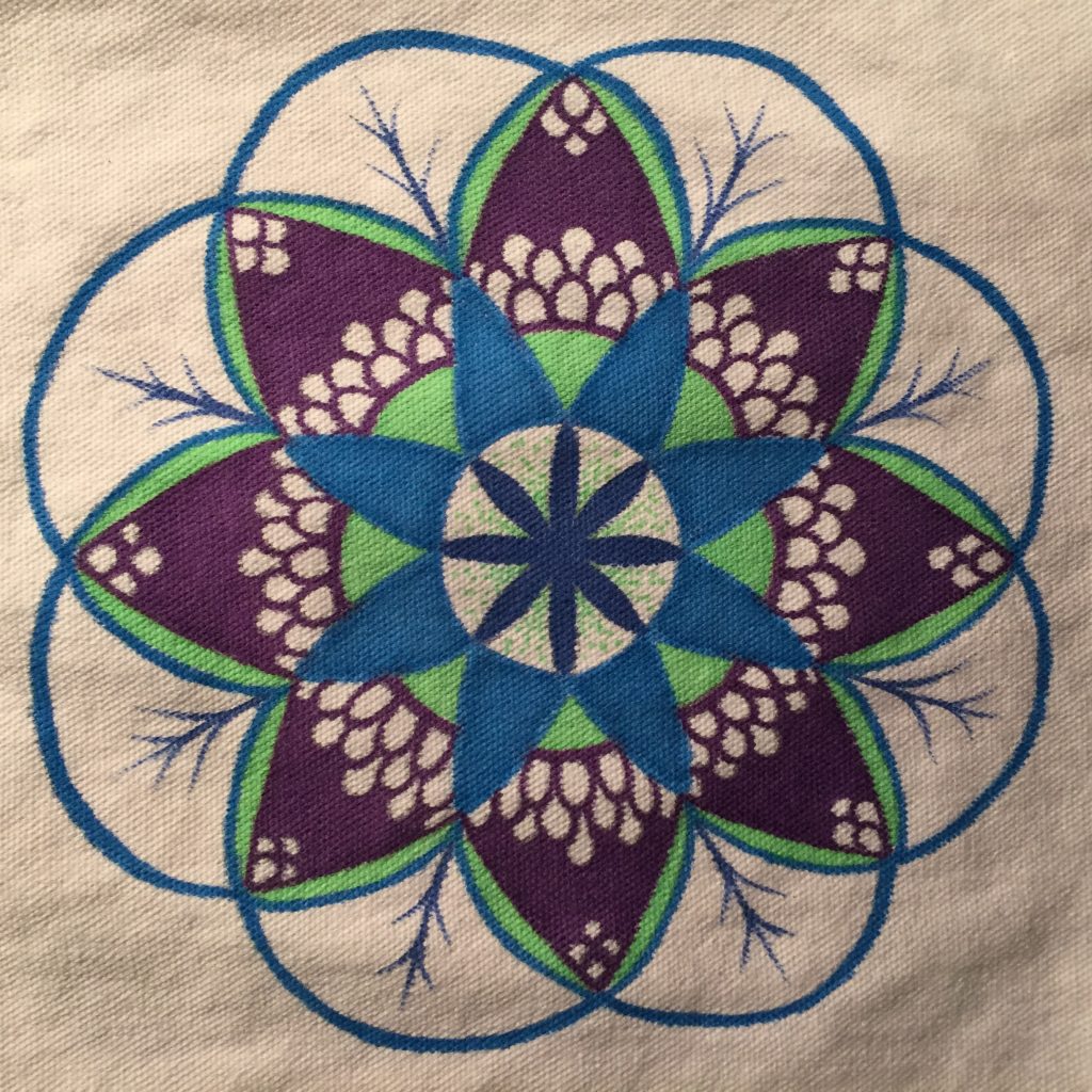 Hand drawn budding flower mandala in green, blue and purple on a white tote bag