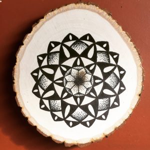 black ink teardrop mandala on wood