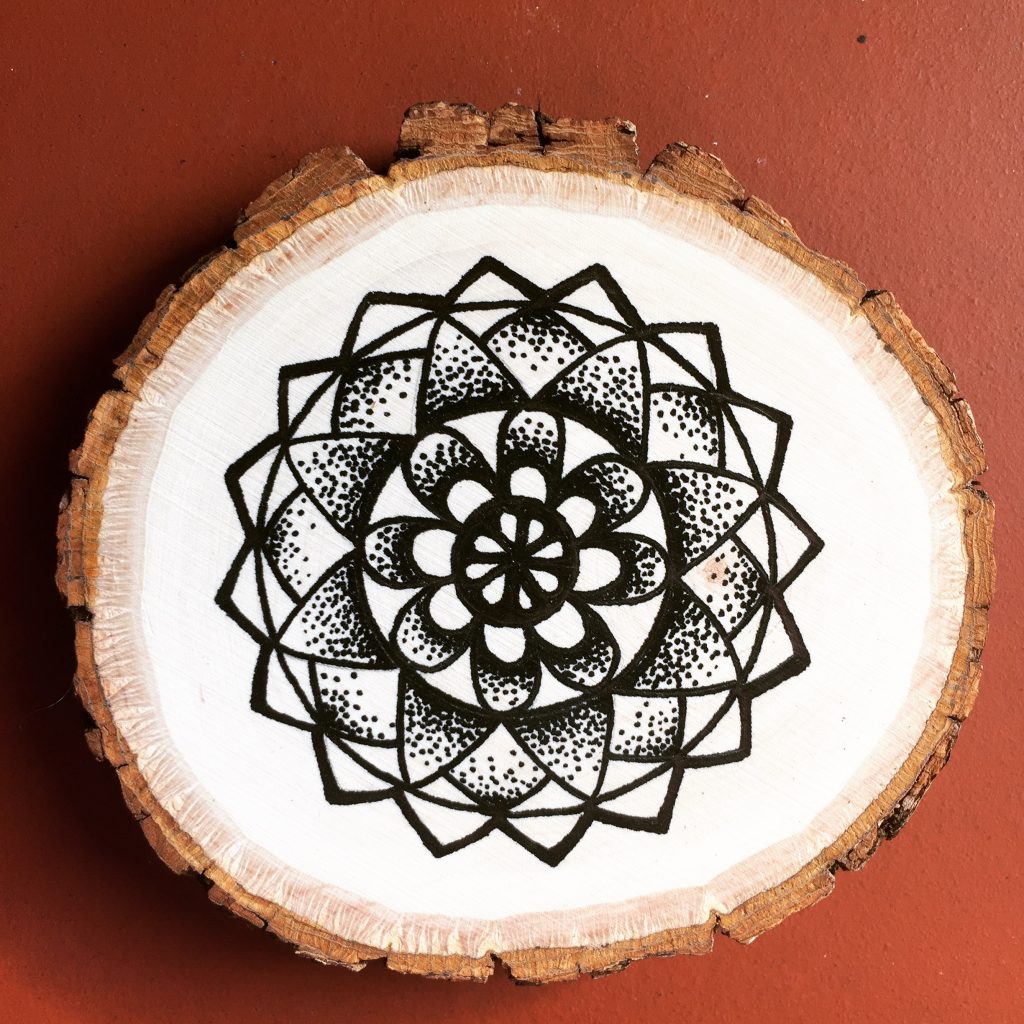 black ink flower mandala on wood