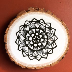 black ink flower mandala on wood